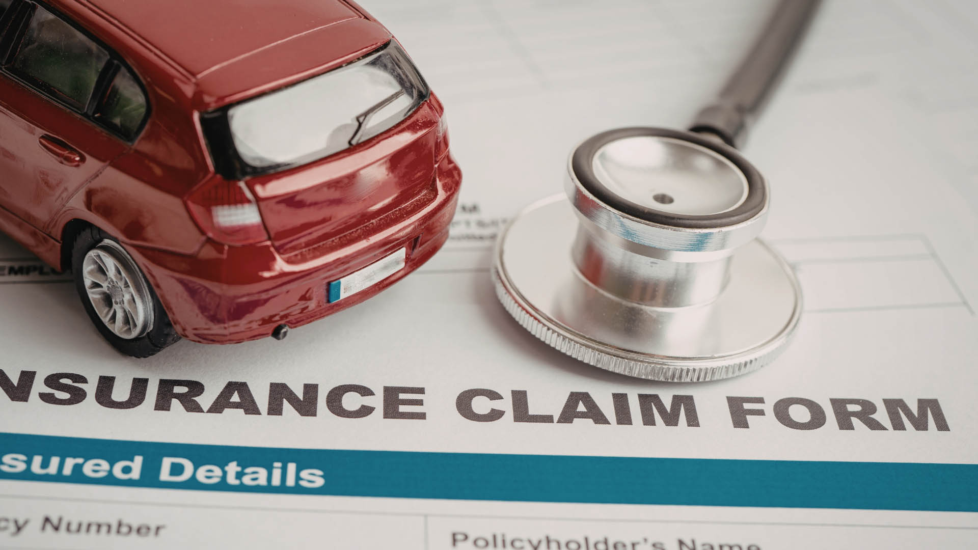 Educational graphic with the text: "Understanding Supplement Payments: Why Your Initial Insurance Check is Too Low" next to an illustration of an insurance check and a magnifying glass over a car.